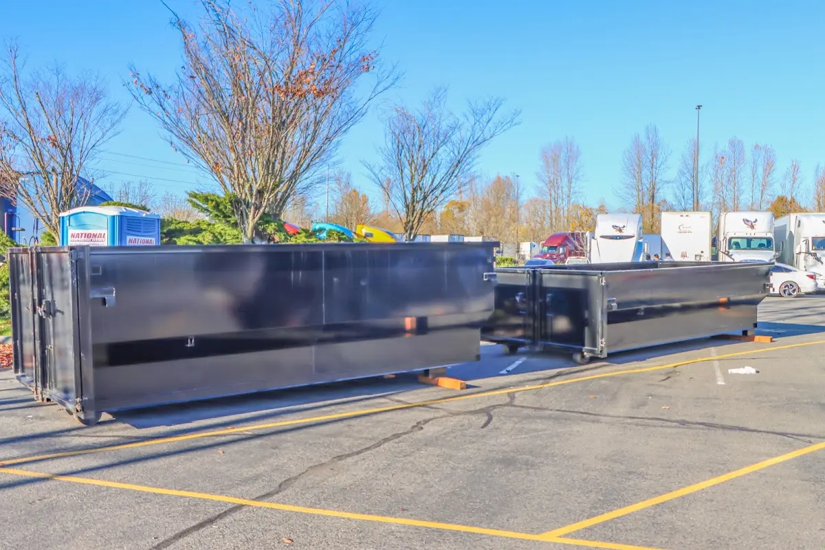 Professional dumpster rental service with roll-off container on residential driveway in Rio Vista